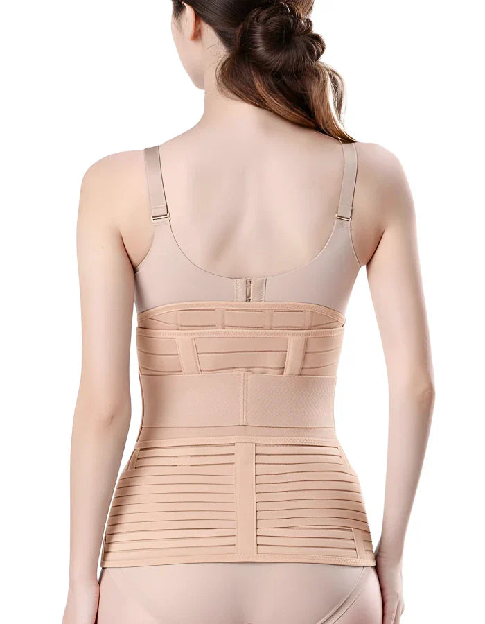 Back view of a woman wearing a beige postpartum C-section recovery belly wrap and a tummy support belt after childbirth.