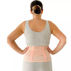 Woman wearing a beige belly support  girdle  back view on a white background.