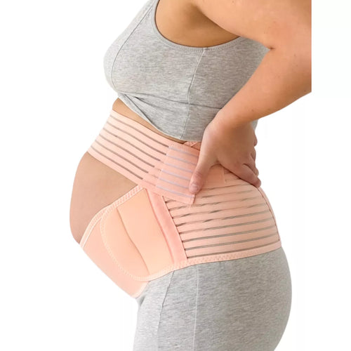 Pregnant woman wearing a beige belly support band on a white background.